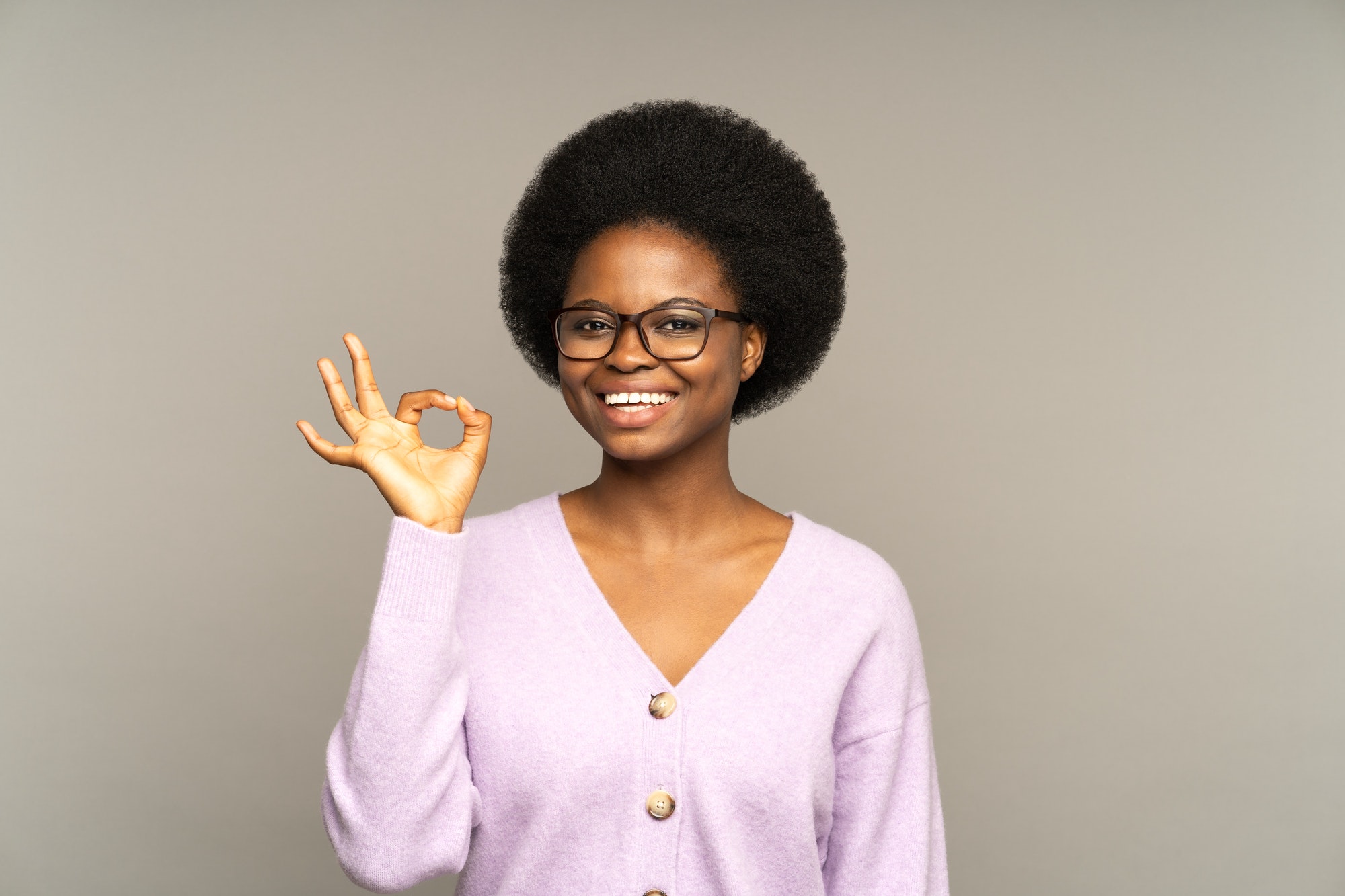 Happy african girl show okay gesture give good advice or help. Satisfied business or service client