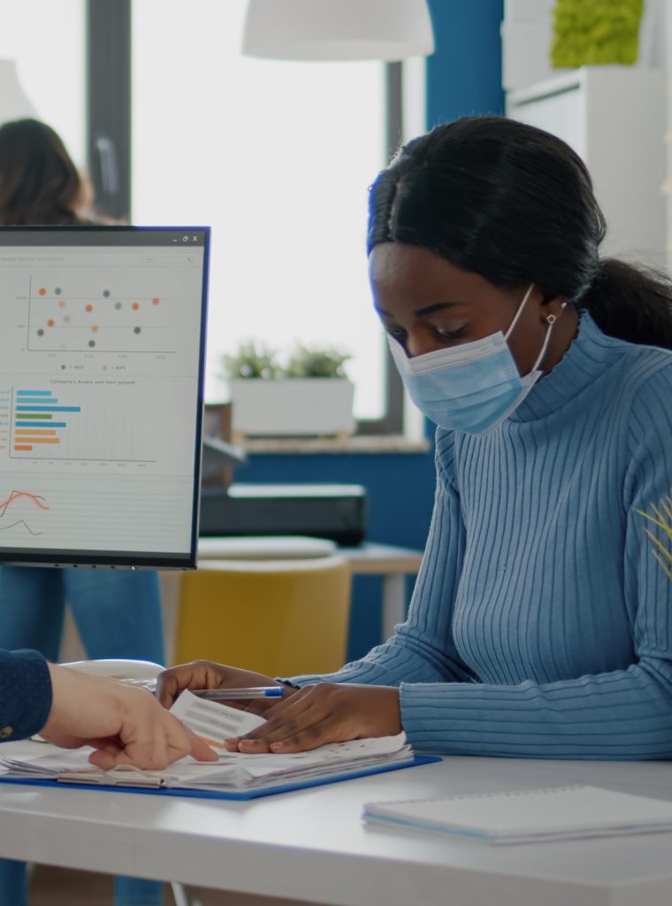 invalid-man-and-african-employee-with-protective-masks-working-together